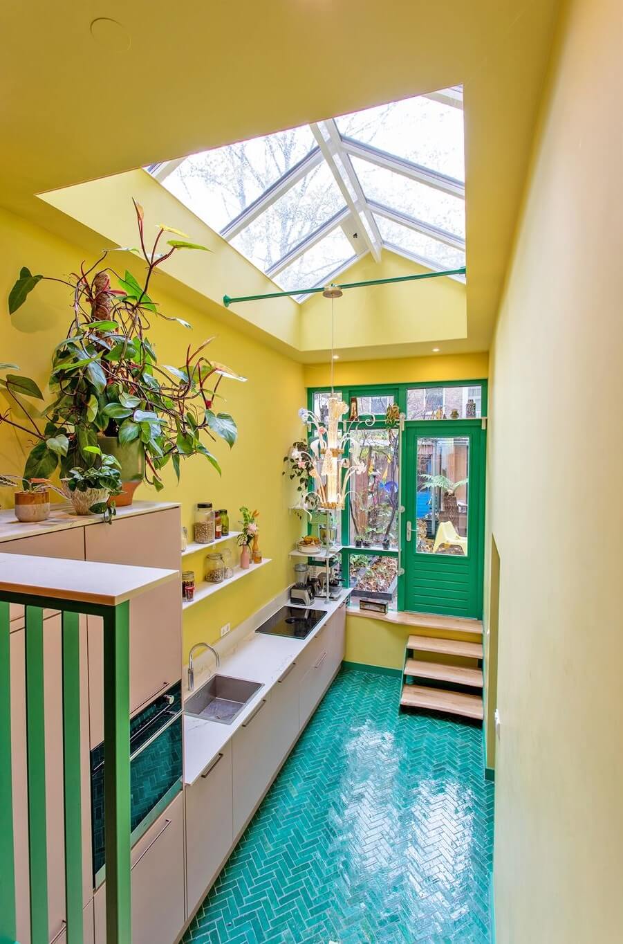 kitchen with yellow walls blue floor tiles and light pink cabinets nordroom