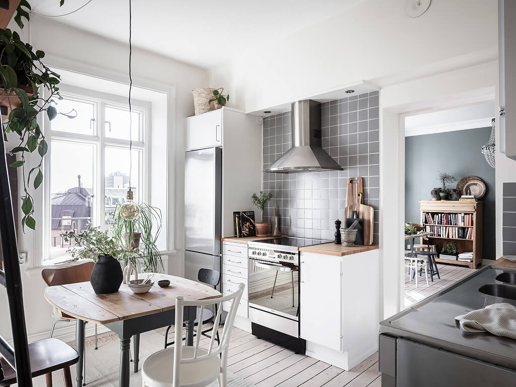 small blue scandinavian apartment nordroom10 A Charming Swedish Apartment with Blue Walls and Plants