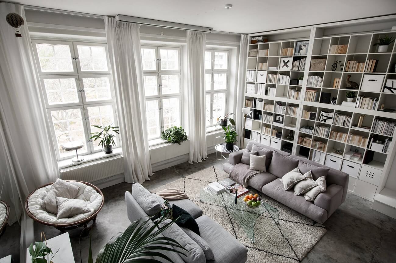 A Small Scandinavian Loft Looks Spacious Thanks To A Mirrored Wall