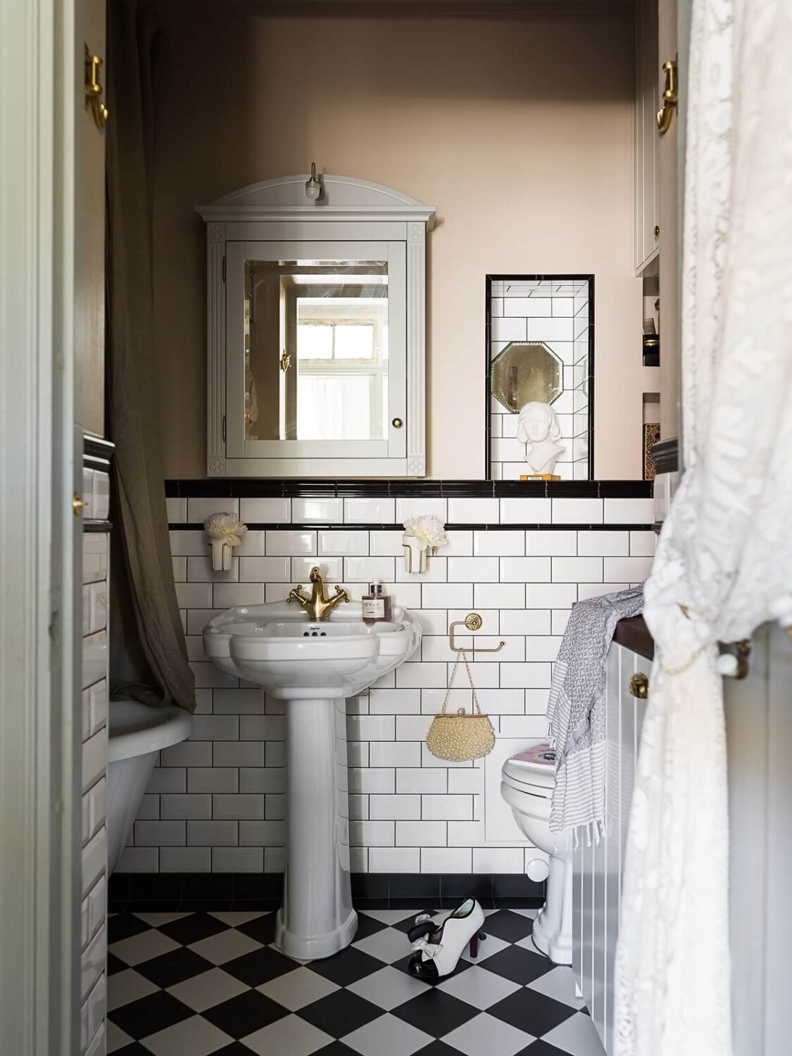 bathroom black white tiles soft pink walls