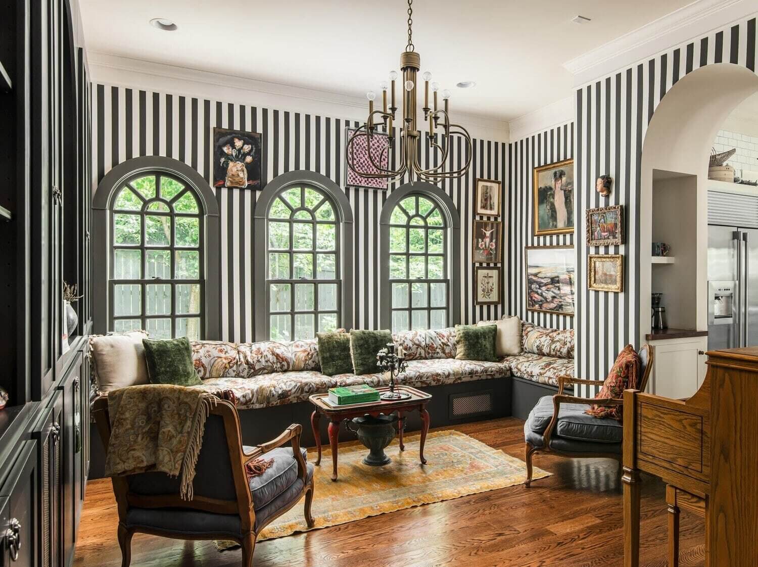 black-white-striped-wallpaper-sitting-room-window-seat-arched-windows-vintage-eclectic-decor