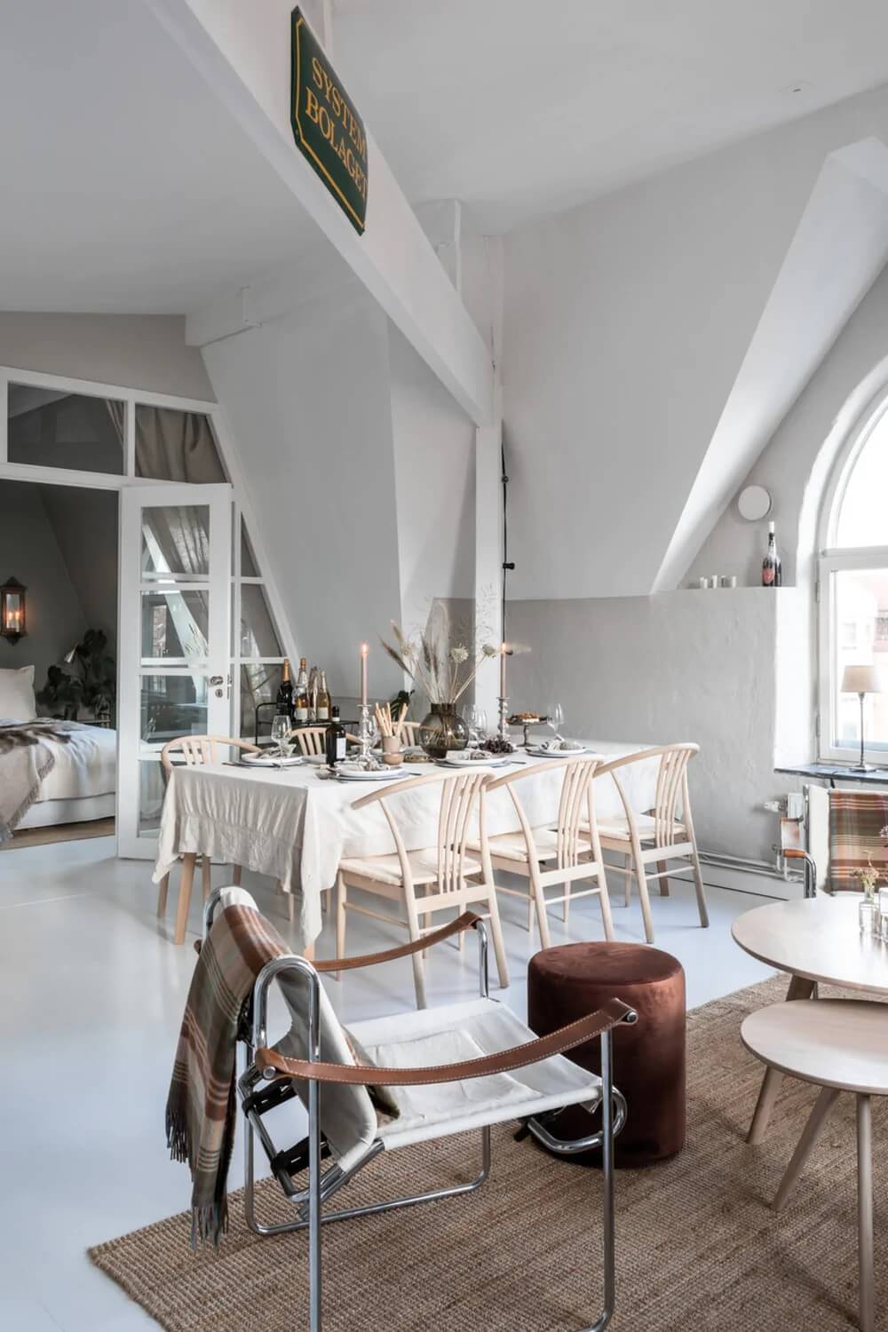 An Attic Apartment Turned Bright with White Paint and Glass Walls