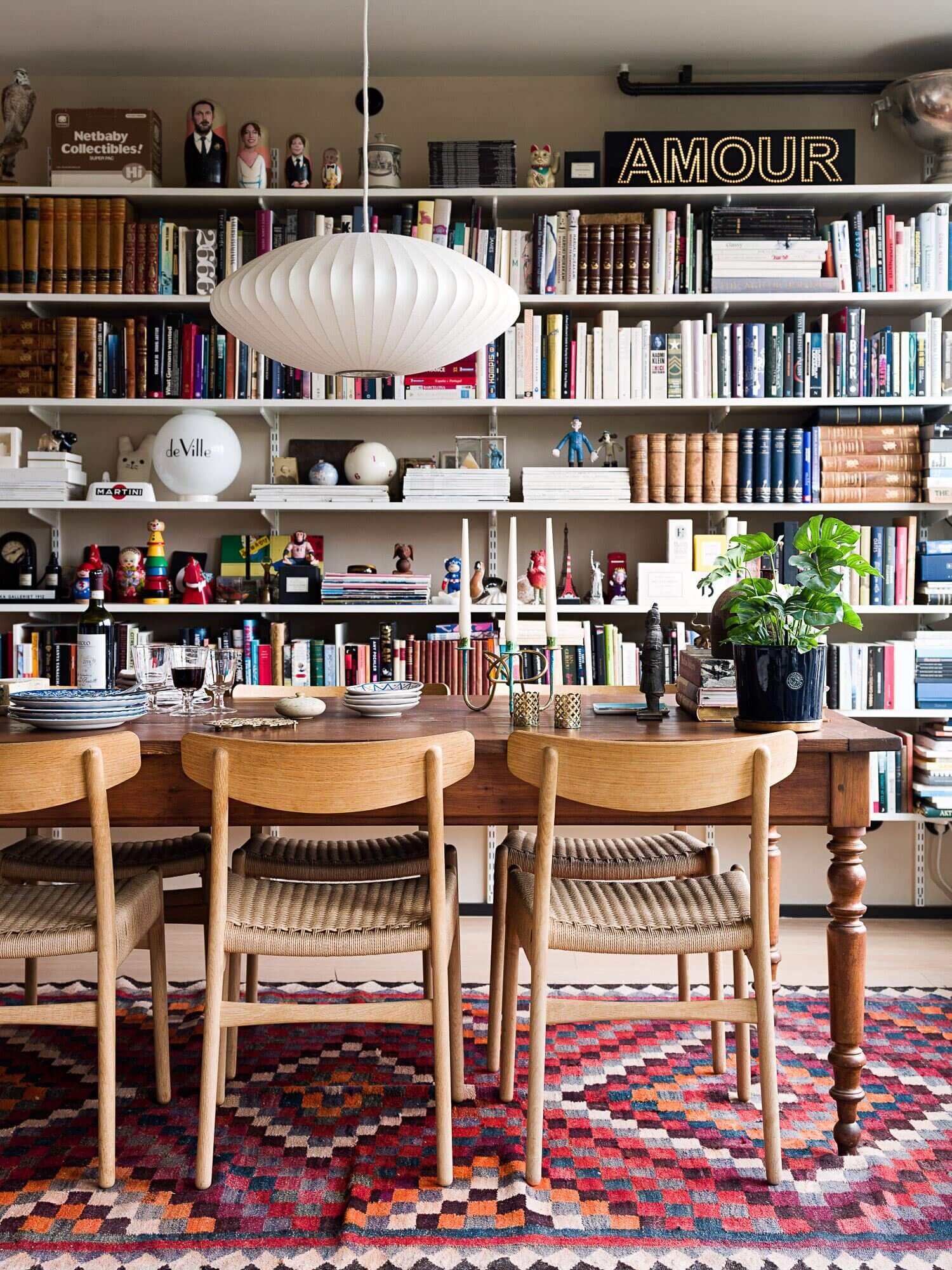 A Light Book-Filled Apartment With A Deep Blue Bedroom