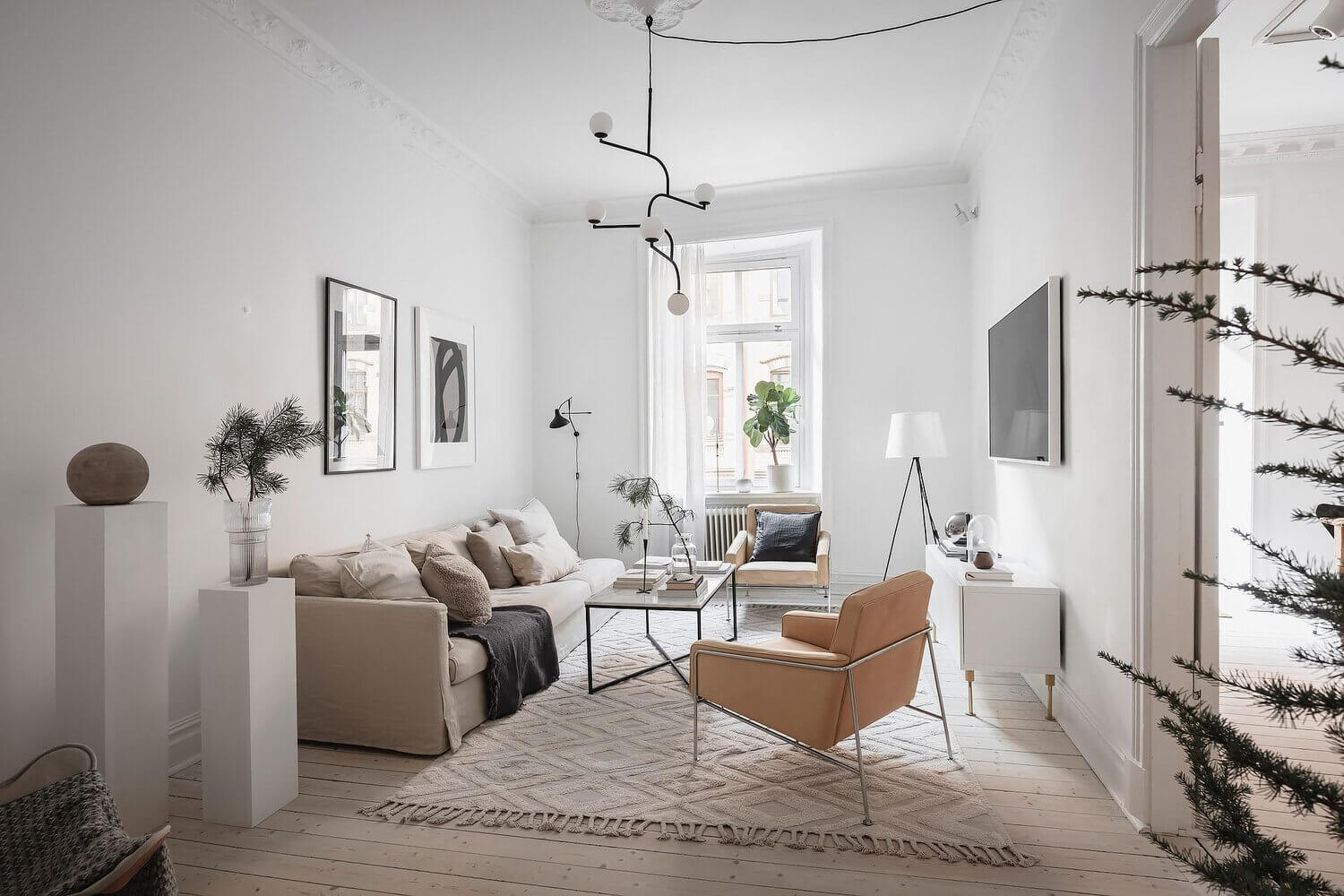 A White Scandinavian Apartment With A Sleek Dark Grey Kitchen
