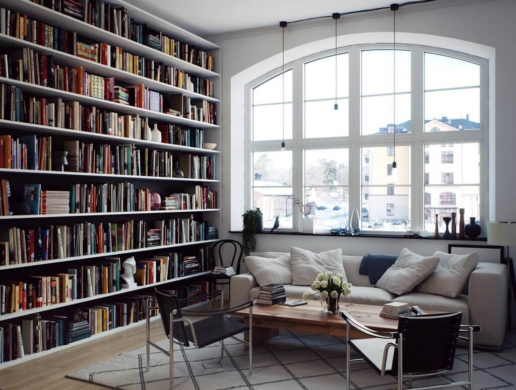 scandinavian-living-room-arched-window-floor-to-ceiling-bookshelves