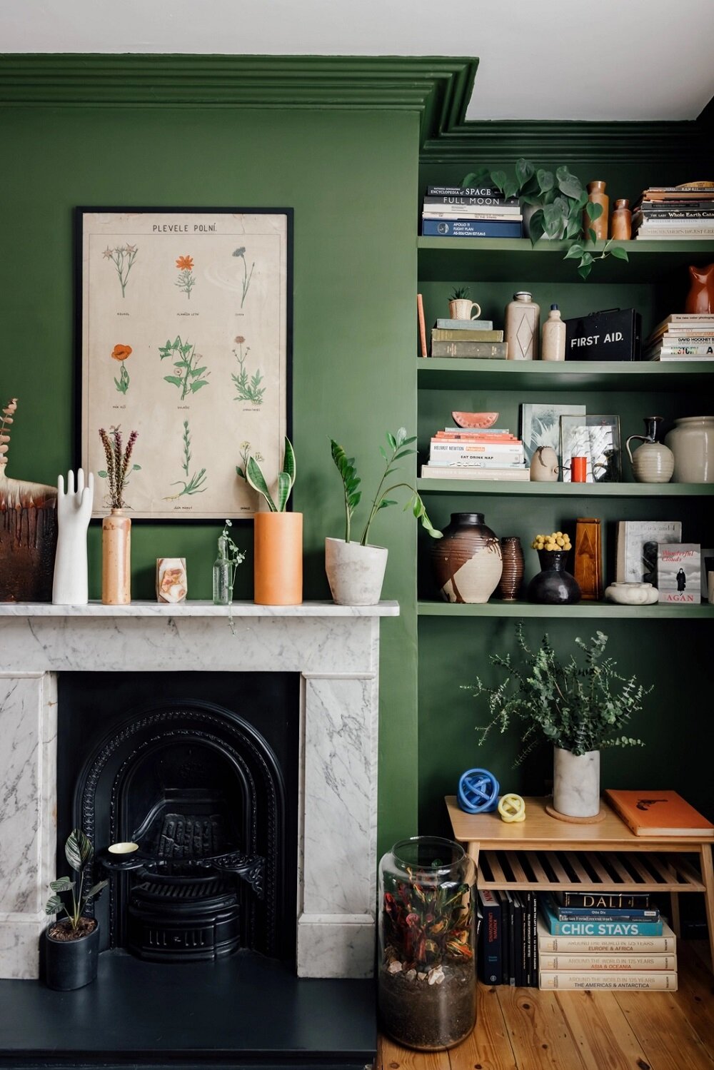 green-living-room-bookshelves-fireplace-nordroom