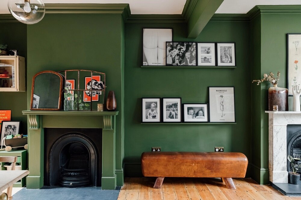 green-living-room-leather-bench-picture-ledge-fireplace-nordroom