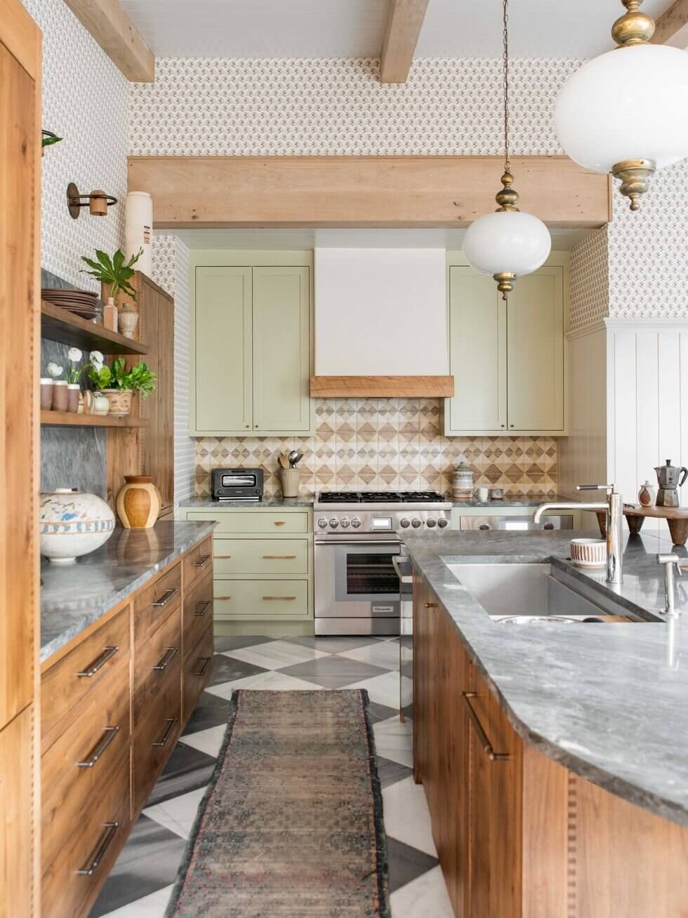 This light green kitchen design is both fresh and inviting, with its soft color palette creating a serene and calming atmosphere. The white countertops and cabinets complement the green walls perfectly, making this space a stylish and modern choice for any home.