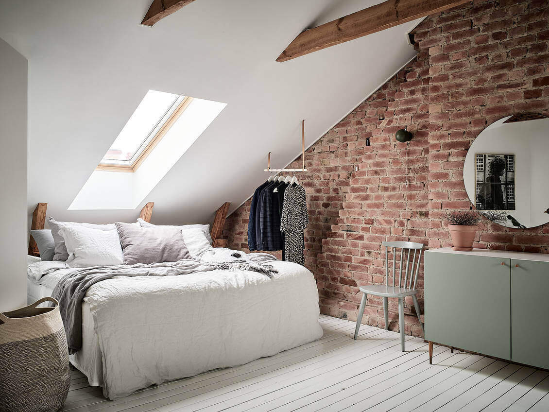 bedroom-slanted-ceiling-hanging-wardrobe-bed-under-eaves-exposed-brick-nordroom