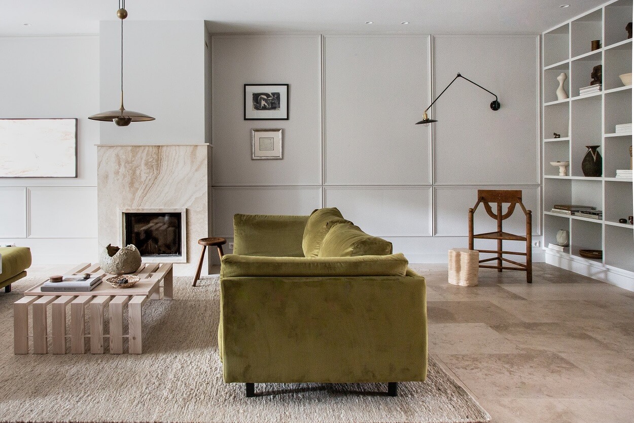 living-room-green-velvet-sofa-limestone-floor-bookshelves-nordroom