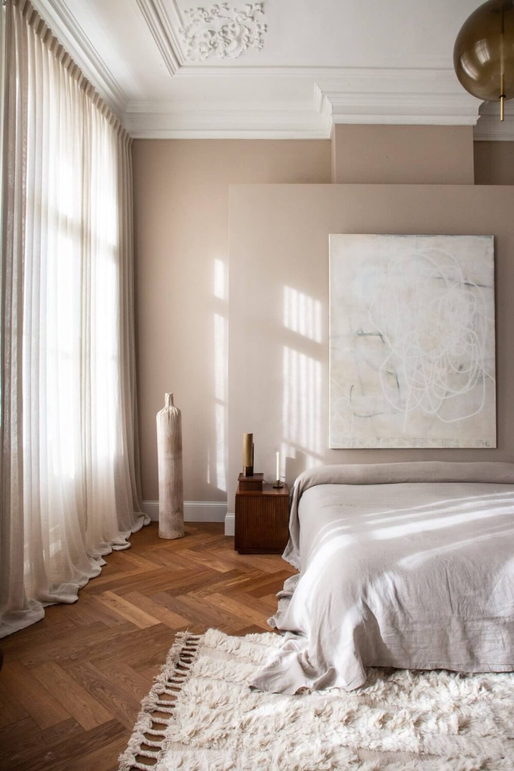 neutral-master-bedroom-artwork-wooden-floor-nordroom