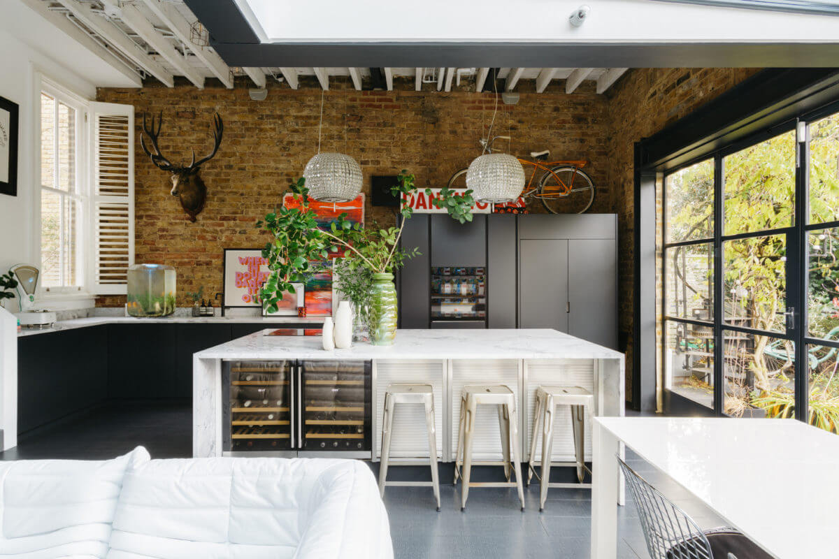 black-white-kitchen-island-exposed-brick-wall-nordroom