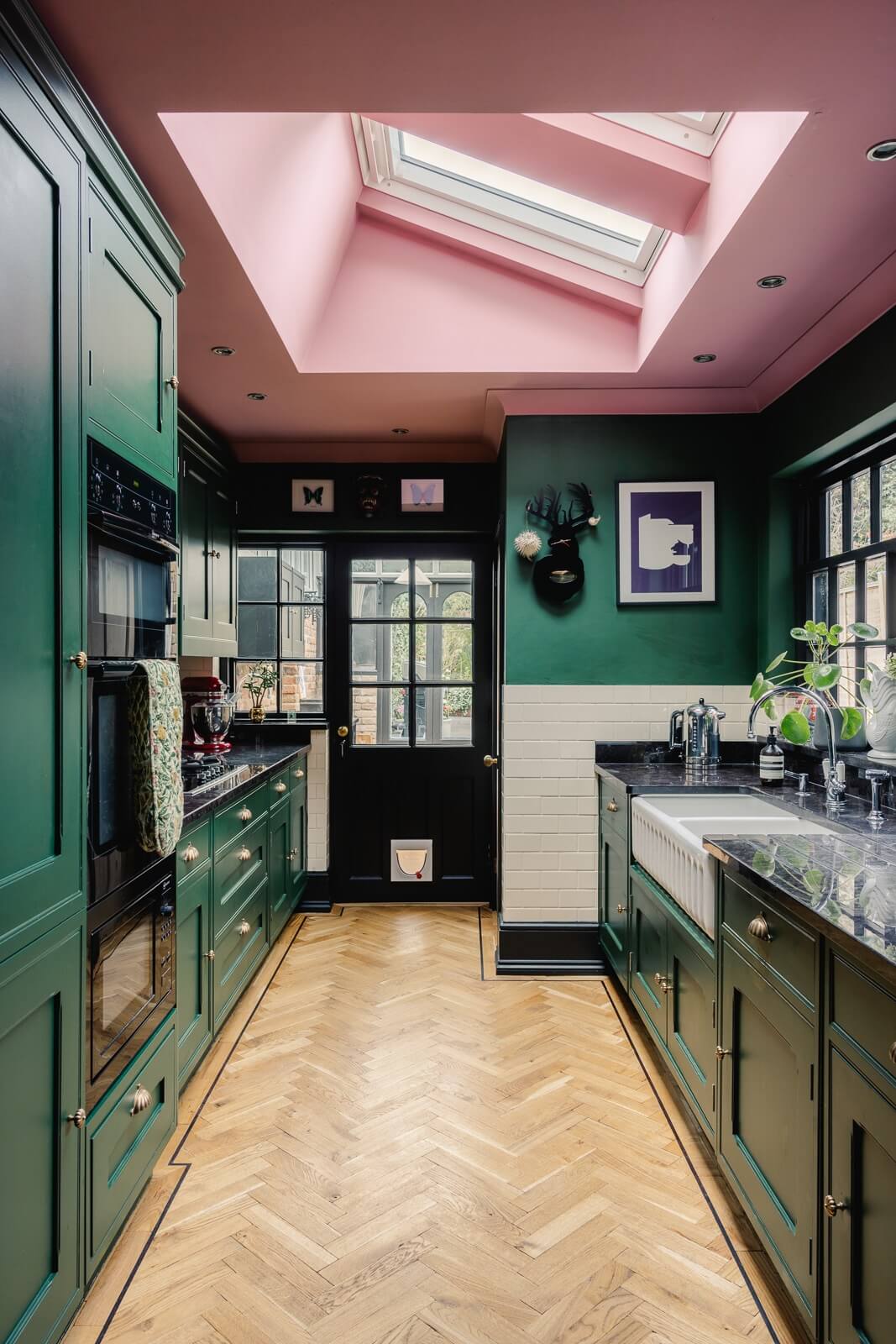 A Green Kitchen with Pink Ceiling in a Colorful London Home