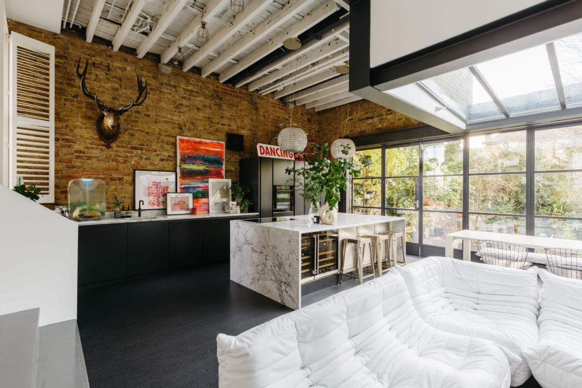 modern-open-plan-kitchen-sitting-room-marble-island-brick-wall-nordroom