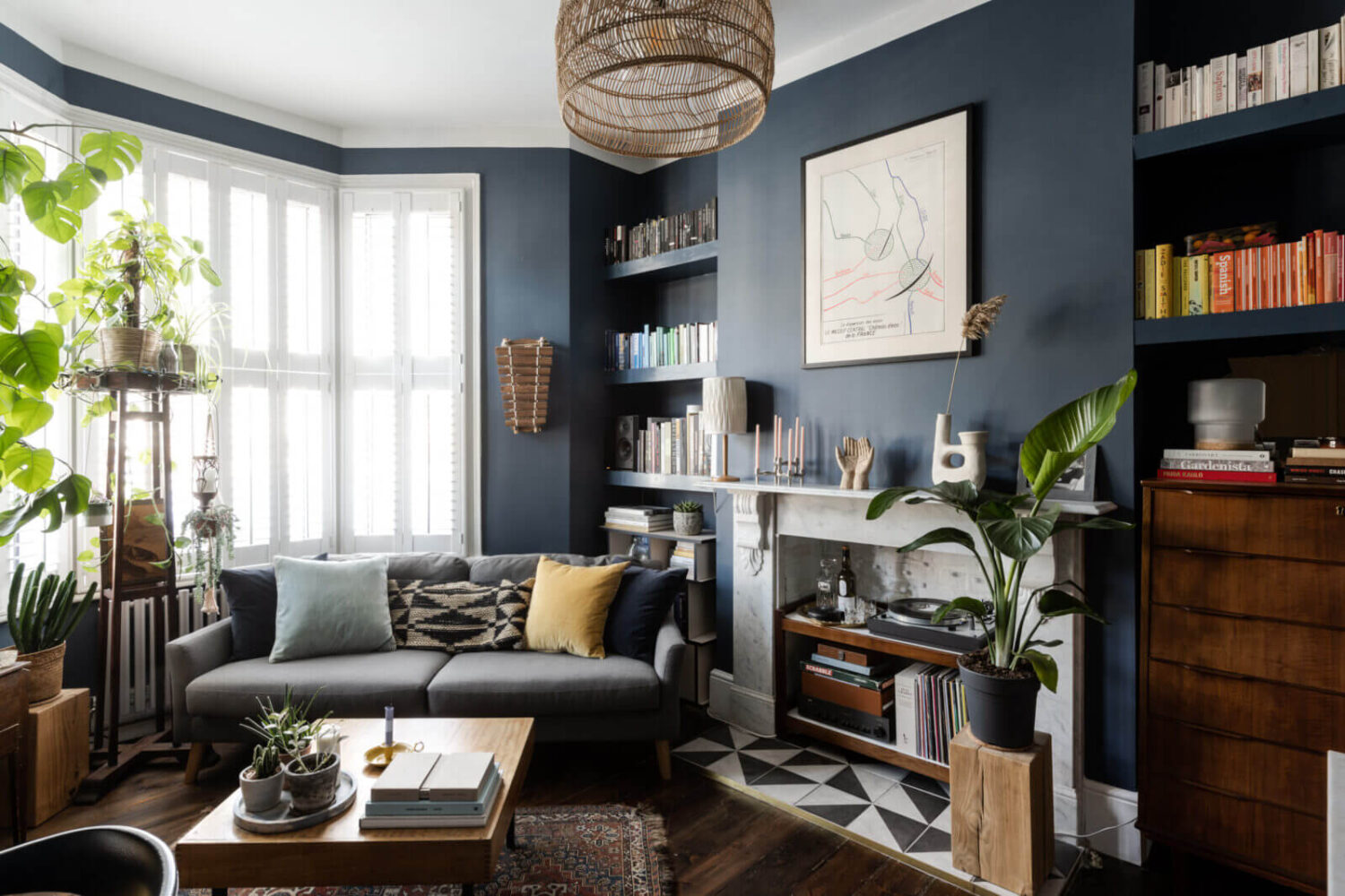 small-dark-blue-living-room-bay-window-fireplace-built-in-bookshelves-nordroom