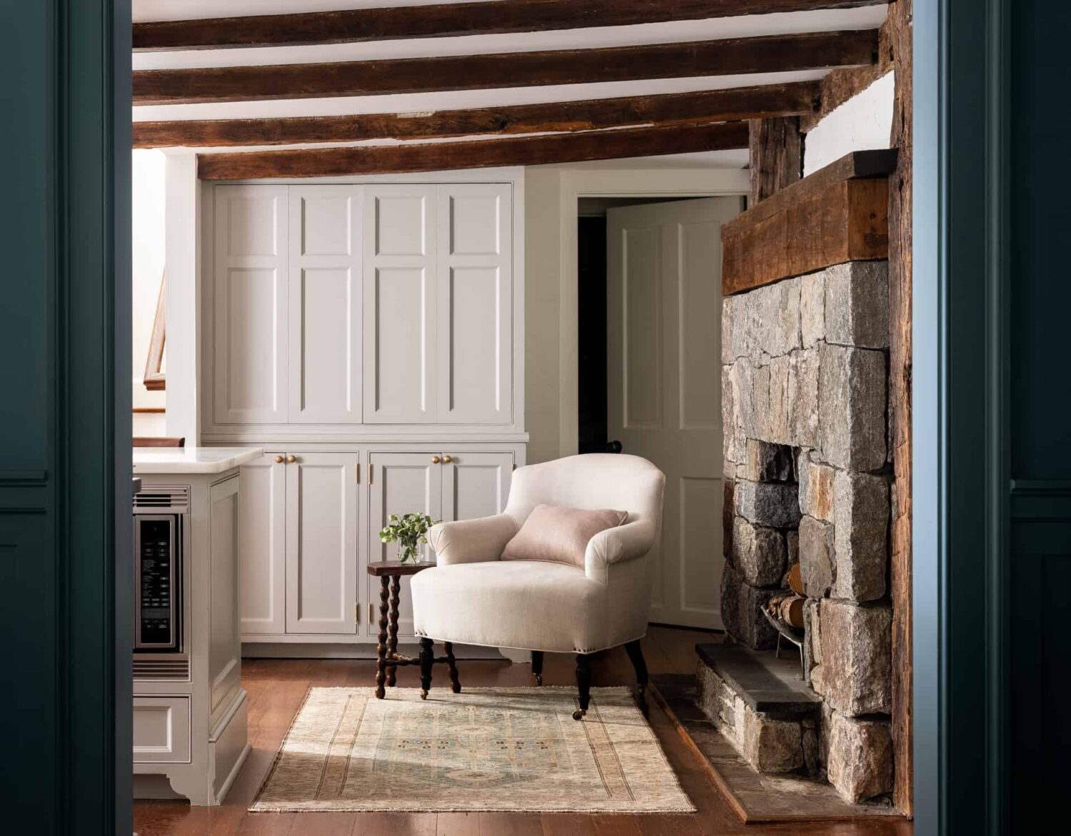 Heidi-Caillier-Design-Hudson-Valley-farmhouse-kitchen-old-beams-pantry-lounge-chair-Nordroom