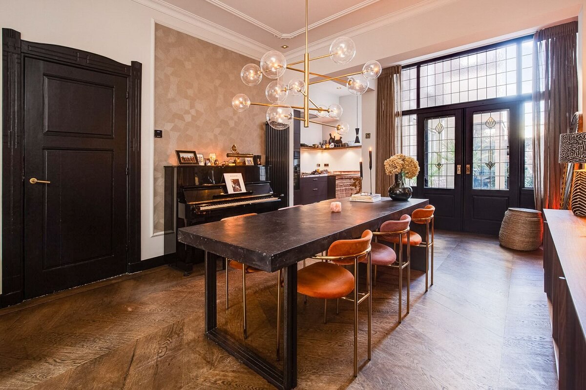 black-dining-table-colorful-chairs-wooden-floor-nordroom