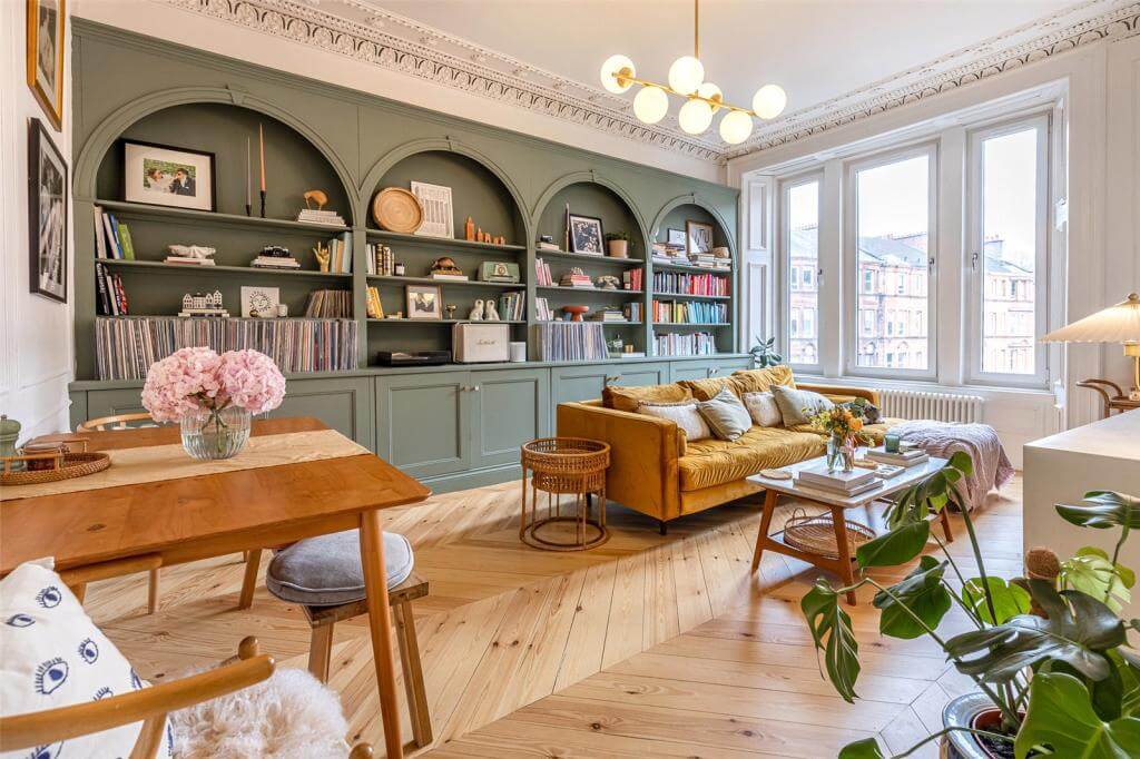 https://www.thenordroom.com/wp-content/uploads/2022/04/living-room-custom-made-green-bookshelves-arches-wooden-floor-nordroom.jpeg