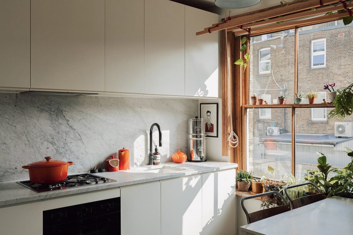 white-kitchen-cabinet-carrara-marble-worktop-stripped-wooden-window-frames-nordroom