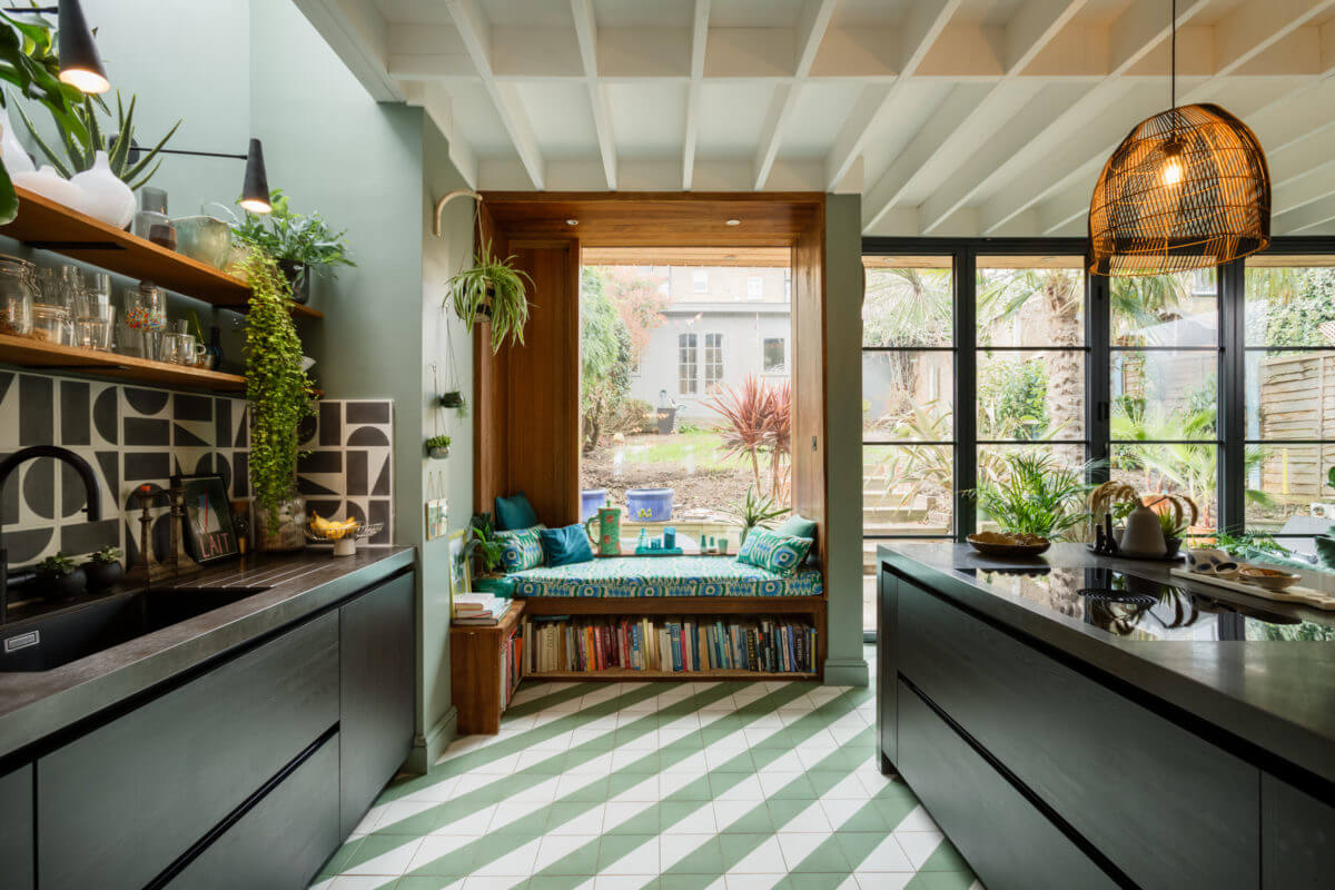 black-kitchen-cabinets-green-walls-window-seat-green-white-diagonal-floor-tiles-nordroom