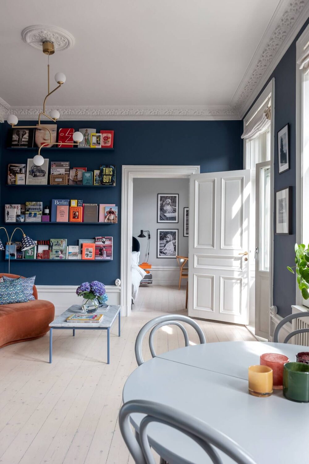 blue-living-room-bookshelves-colorful-apartment-nordroom
