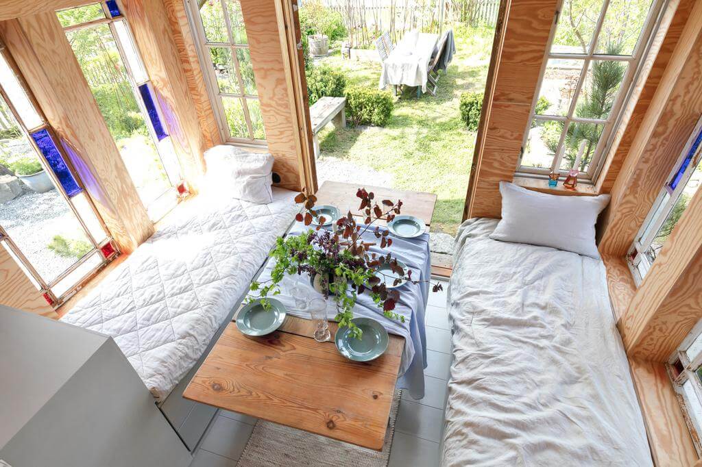 daybed dining area swedish cottage nordroom A Red Wooden Cottage on a Swedish Allotment