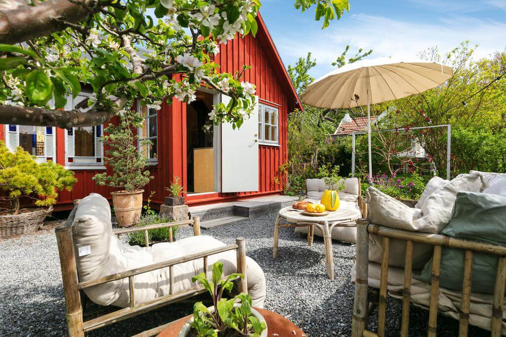 garden seating red wooden cottage sweden nordroom A Red Wooden Cottage on a Swedish Allotment