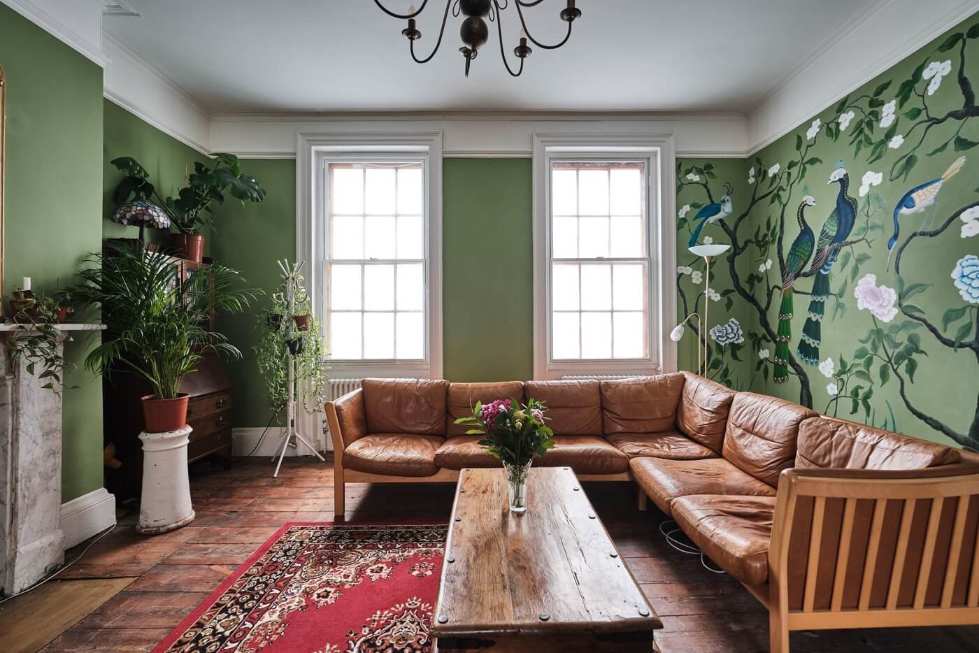 green-sitting-room-tan-leather-sofa-green-mural-nordroom