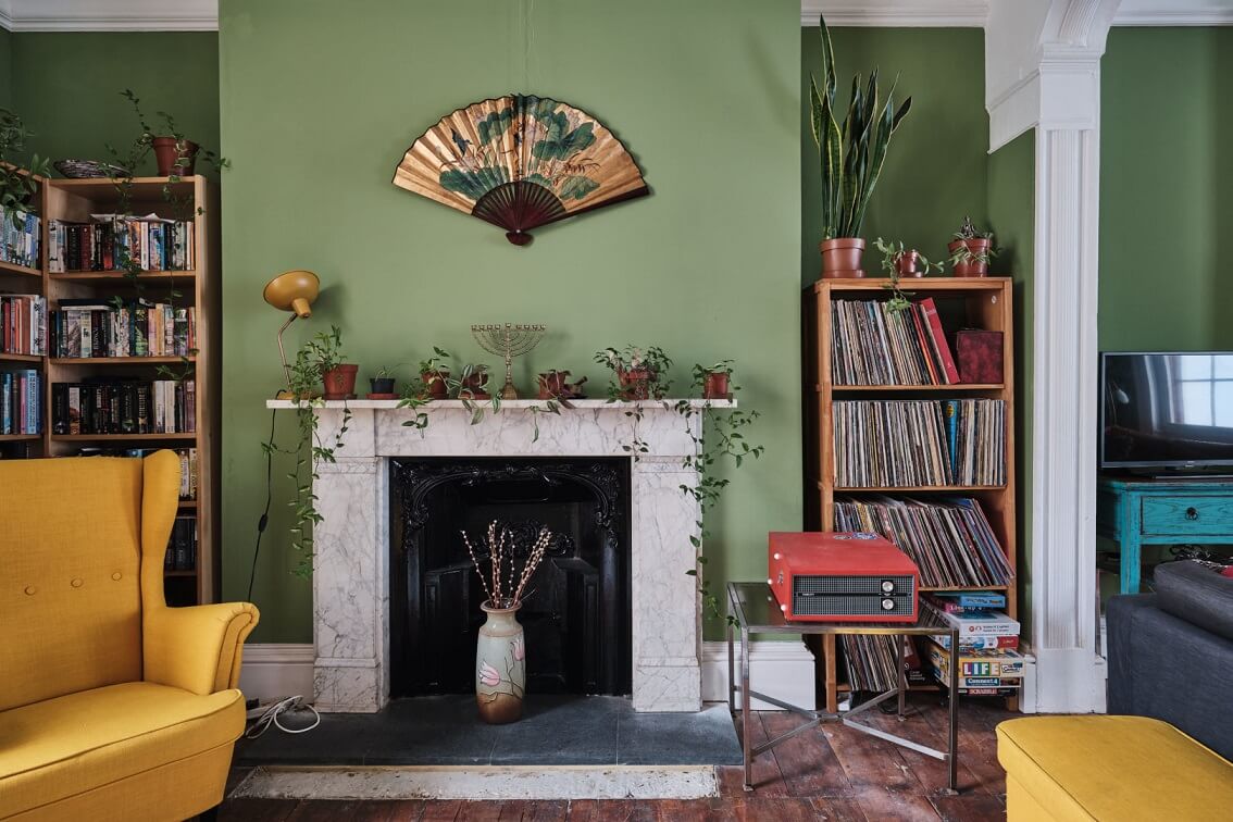 green-sitting-room-yellow-armchair-fireplace-nordroom