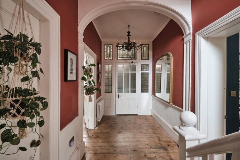 hallway-original-details-red-walls-arched-doorway-wooden-floor-nordroom