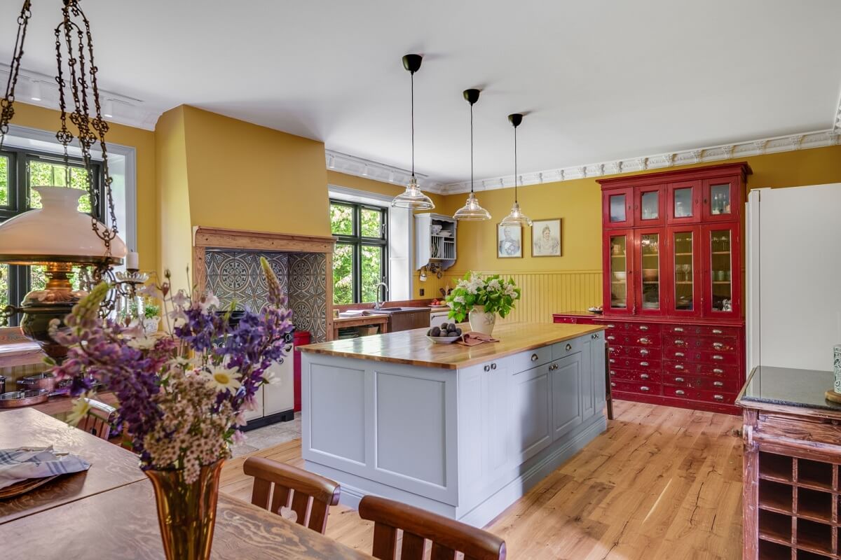 kitchen-with-island-yellow-walls-wooden-floor-nordroom