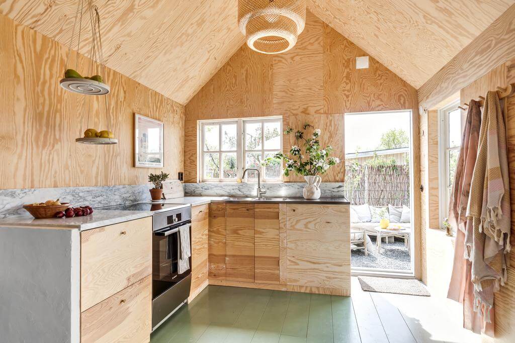 modern wooden kitchen green painted floorboards nordroom A Red Wooden Cottage on a Swedish Allotment