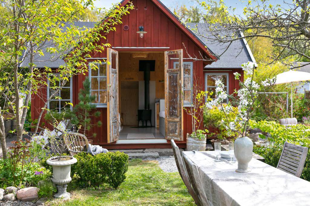 red wooden cottage double doors garden nordroom A Red Wooden Cottage on a Swedish Allotment