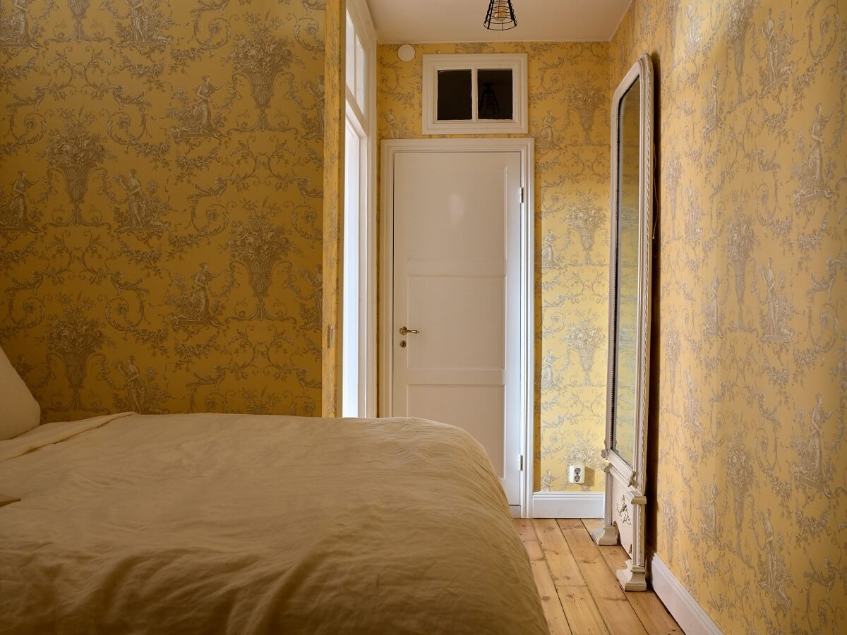 yellow-bedroom-French-wallpaper-large-mirror-nordroom