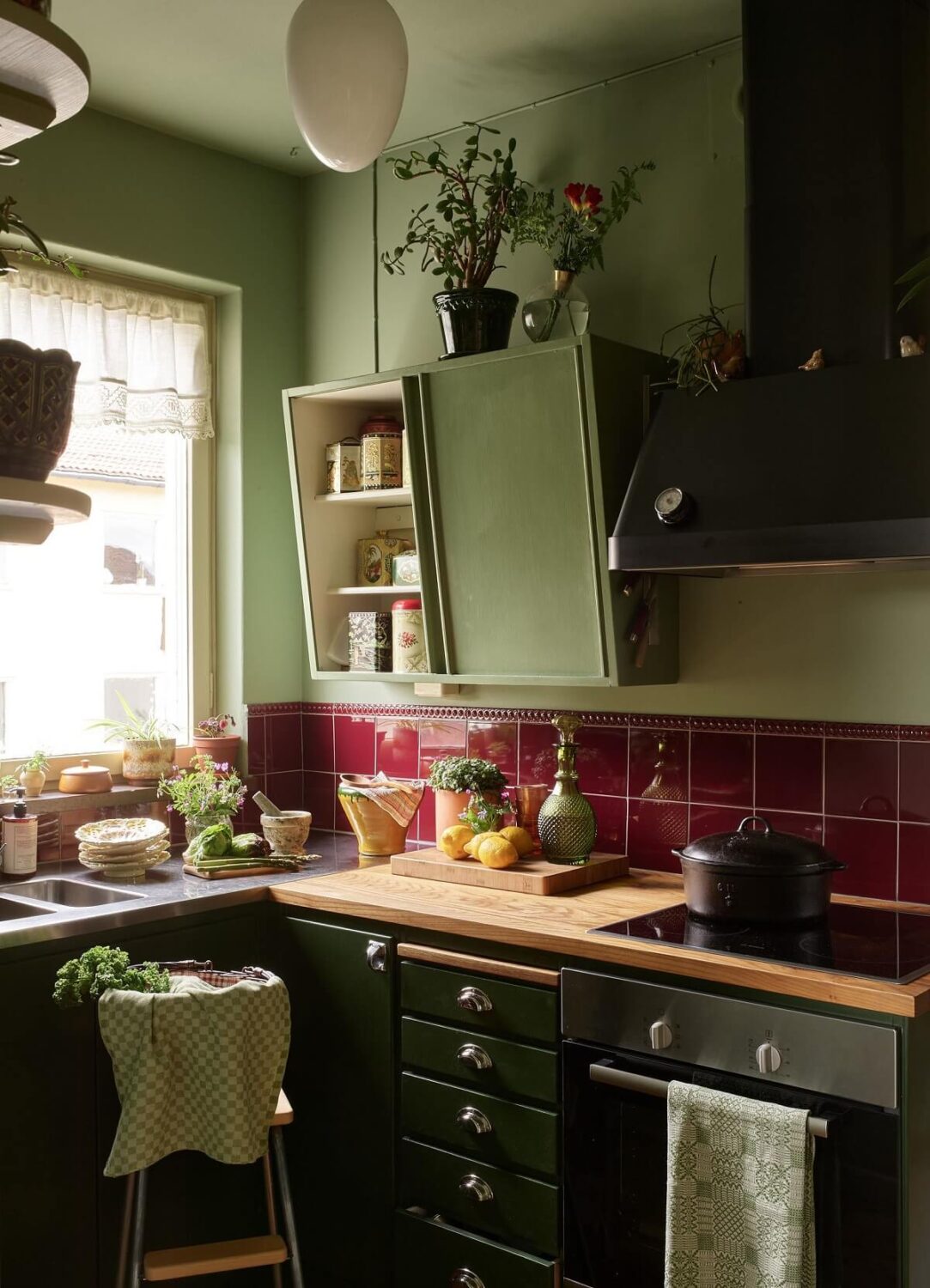 Midcentury Furniture in a Pink and Green Home 1 green-vintage-style-kitchen-burgundy-tiles-nordroom