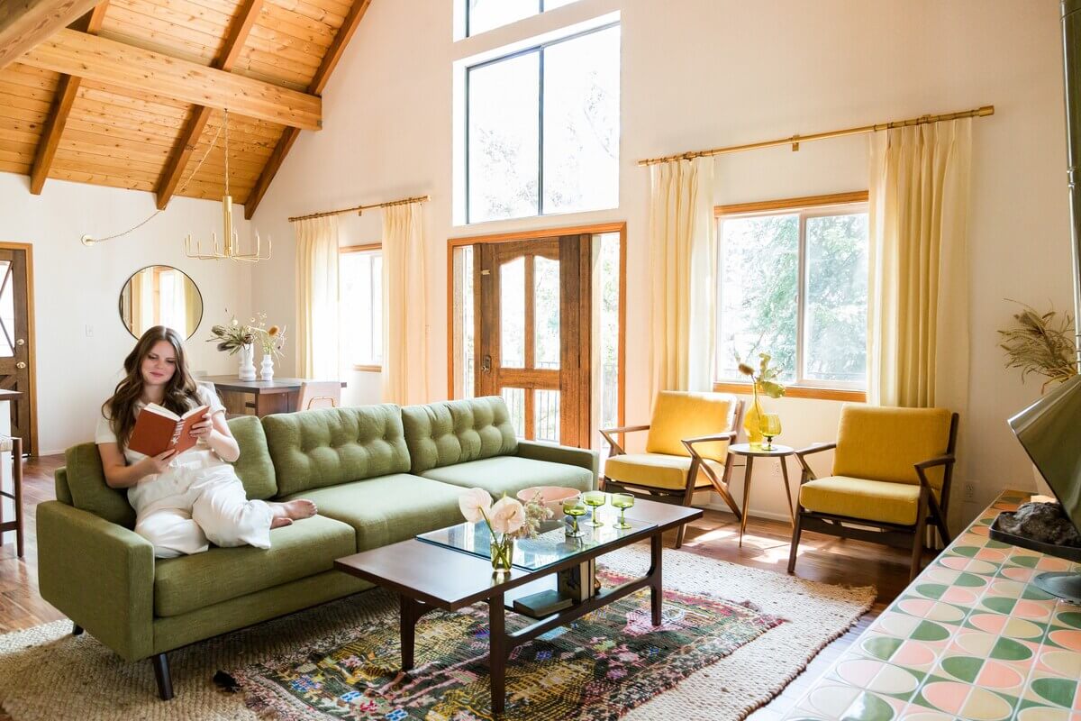 living-room-green-sofa-midcentury-yellow-armchairs-wooden-ceiling-nordroom