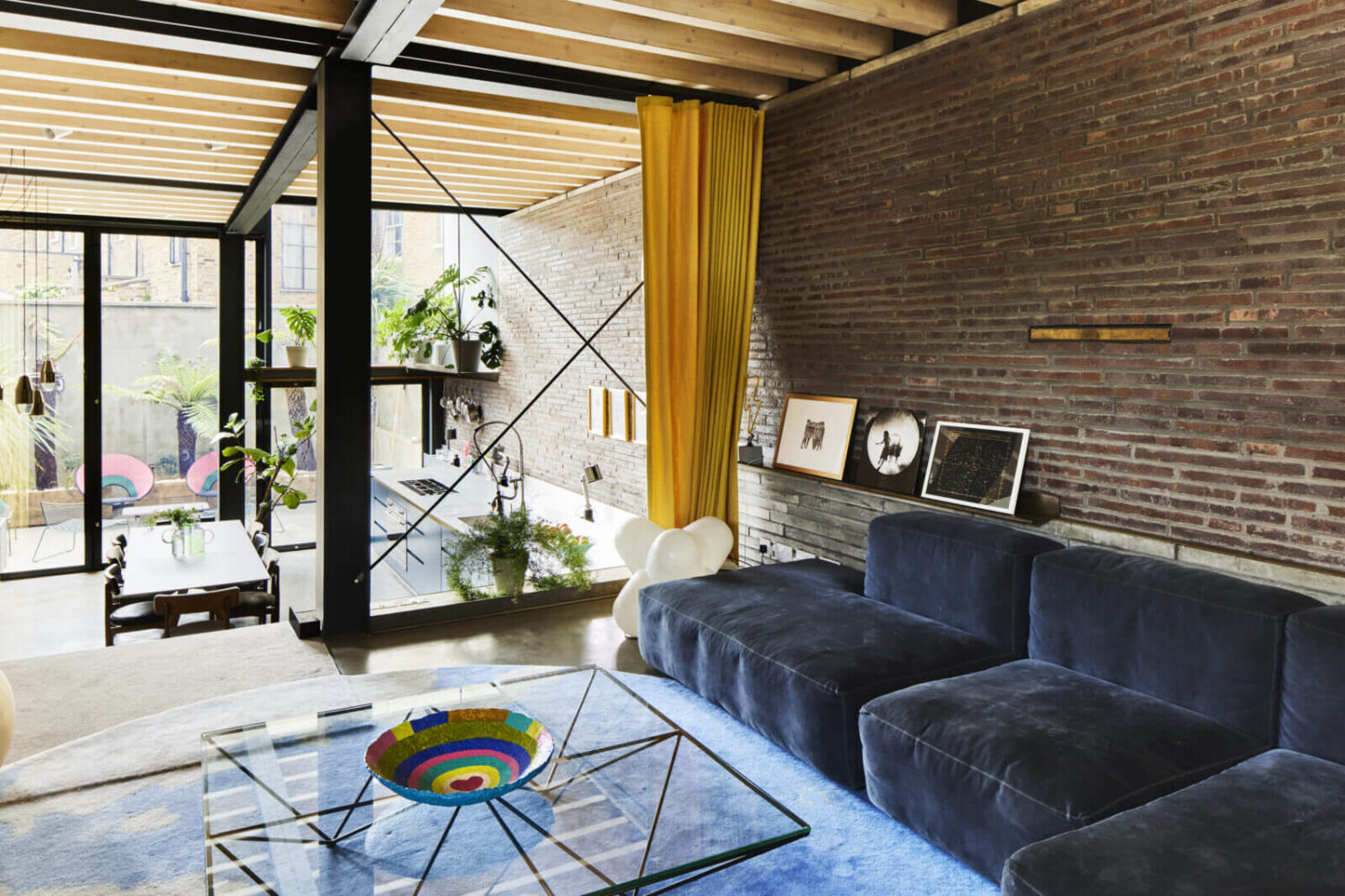 split-level-living-room-blue-sofa-brick-wall-nordroom
