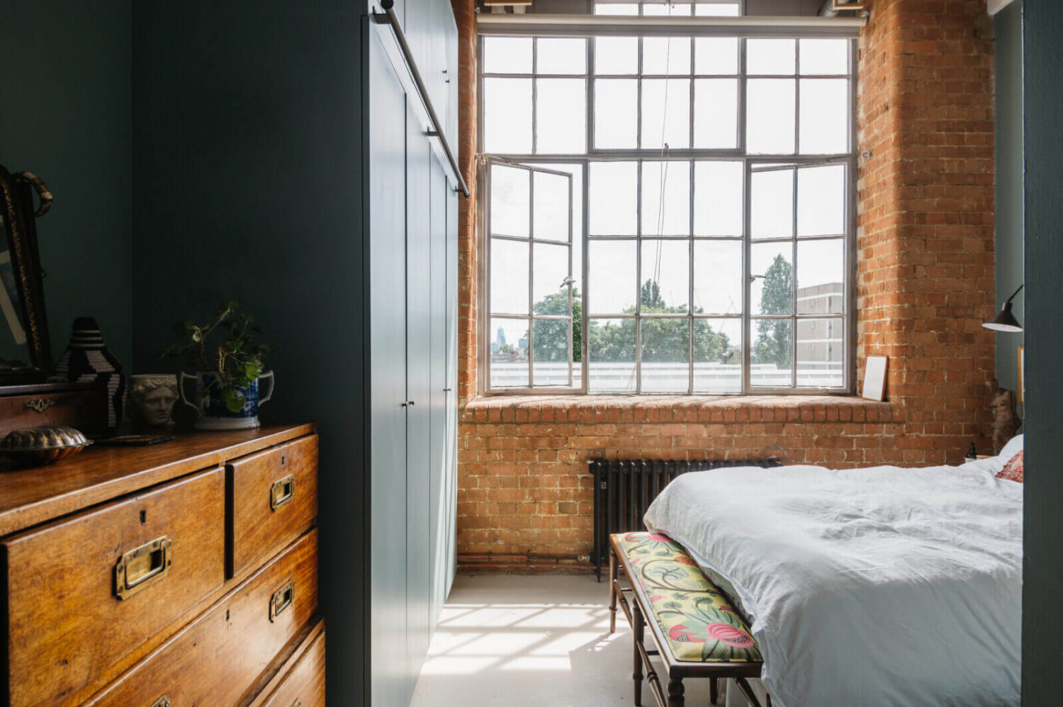 bedroom-brick-walls-industrial-windows-blue-walls-built-in-wardrobes-nordroom