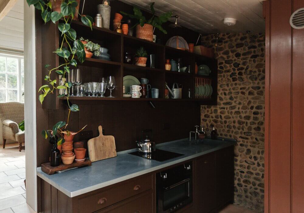 brown-kitchen-cabinets-stone-wall-open-cabinets-nordroom