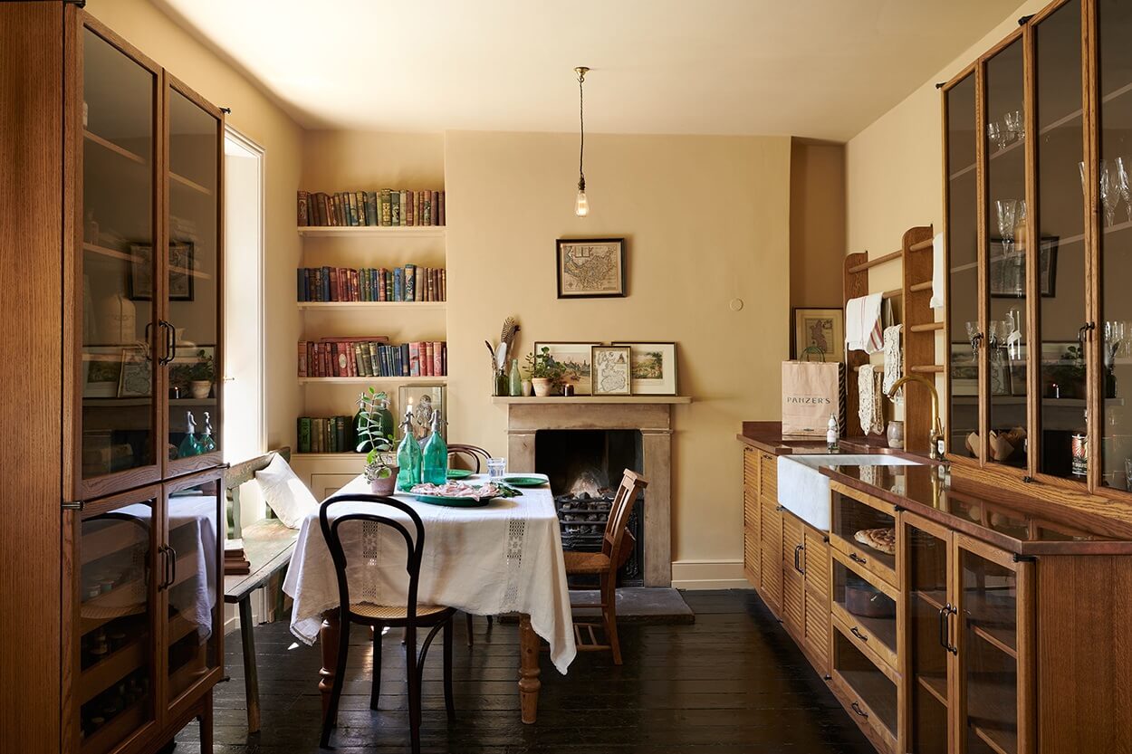 devol-haberdasher-kitchen-warm-yellow-walls-fireplace-nordroom