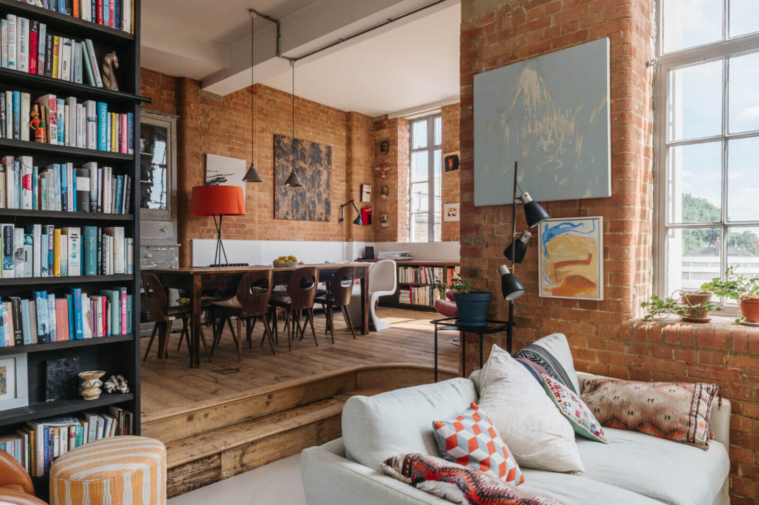 loft-style-living-space-industrial-brick-walls-bookshelves-nordroom