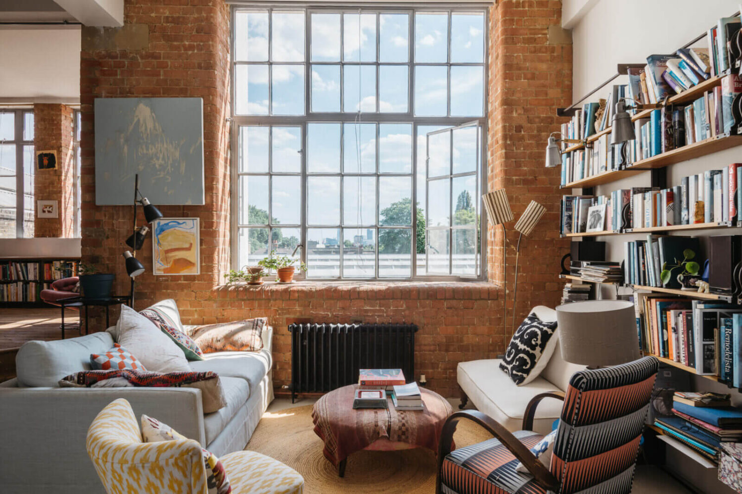 loft-style-sitting-room-brick-walls-bookshelves-nordroom