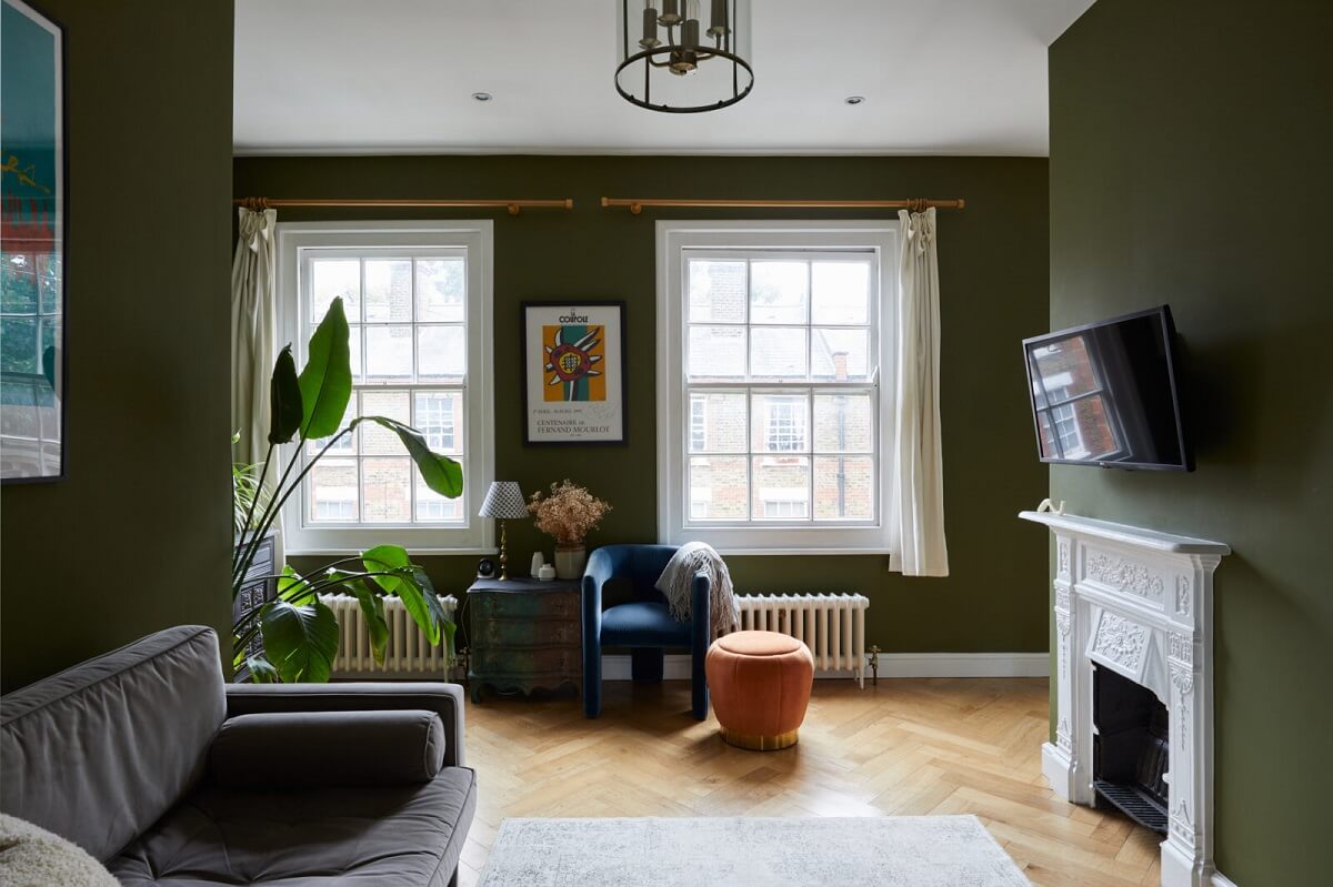 living-room-olive-green-walls-white-fireplace-dark-gray-sofa-nordroom