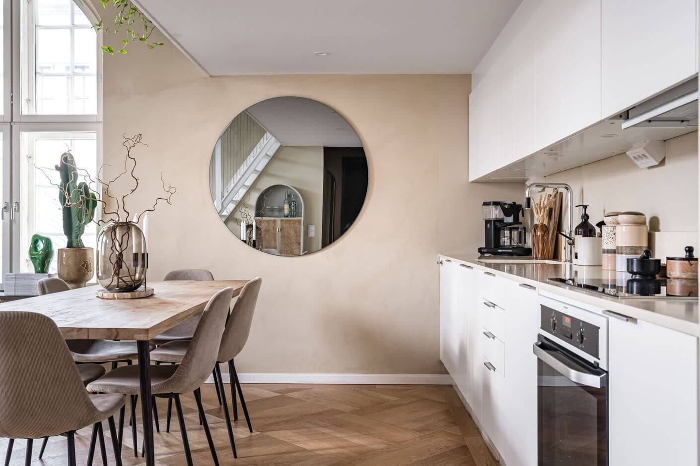 white-kitchen-cabinet-round-mirror-dining-table-nordroom