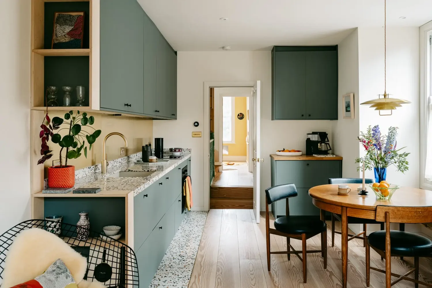 green-kitchen-cabinets-terrazzo-worktops-tiles-round-dining-table-nordroom