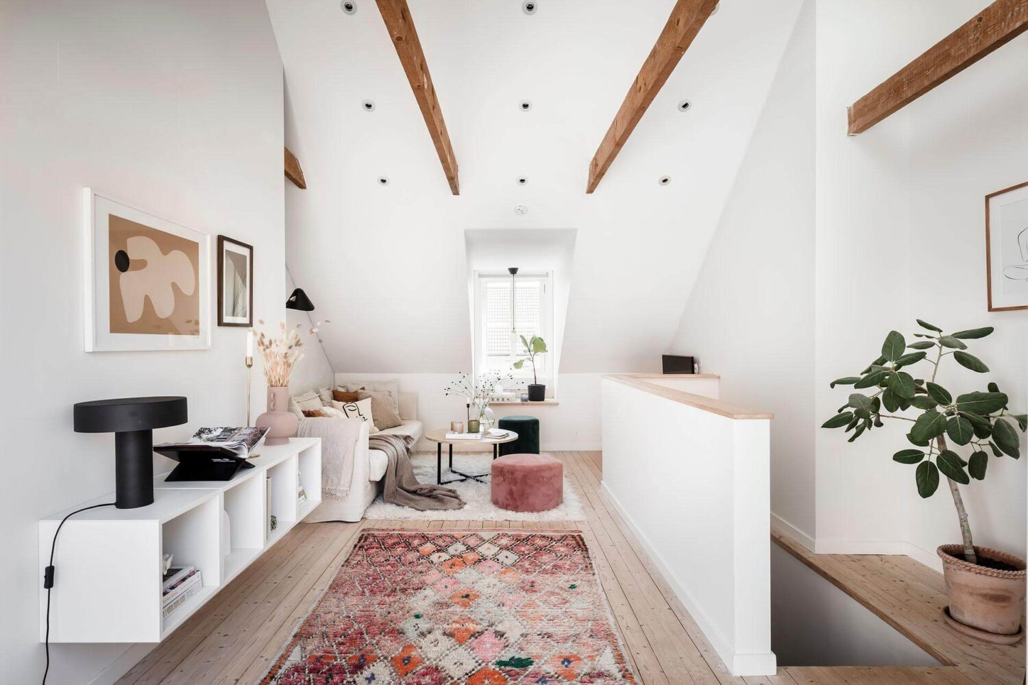 light-attic-living-room-exposed-beams-wall-mounted-cabinets-wooden-floor-nordroom