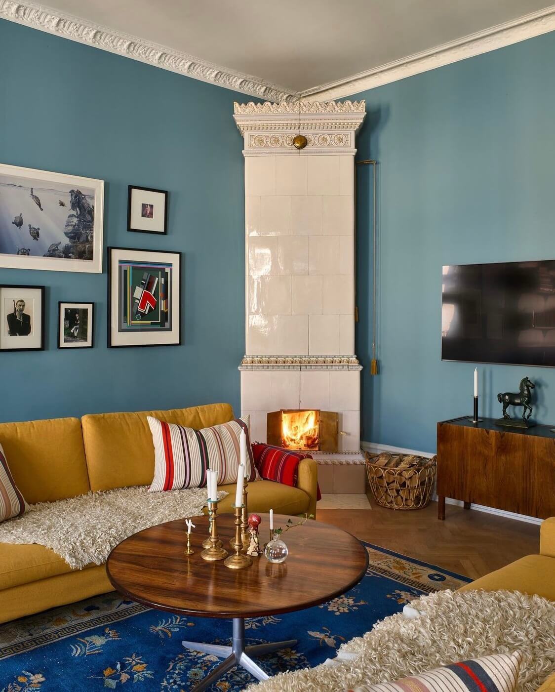 living-room-blue-walls-ochre-yellow-sofa-fireplace-blue-rug-nordroom