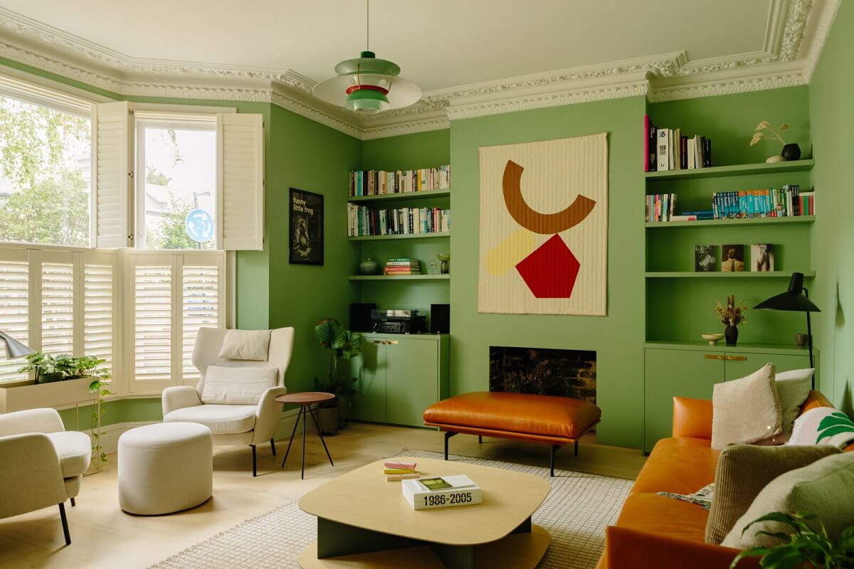 living-room-green-walls-fireplace-bay-window-built-in-bookshelves-nordroom