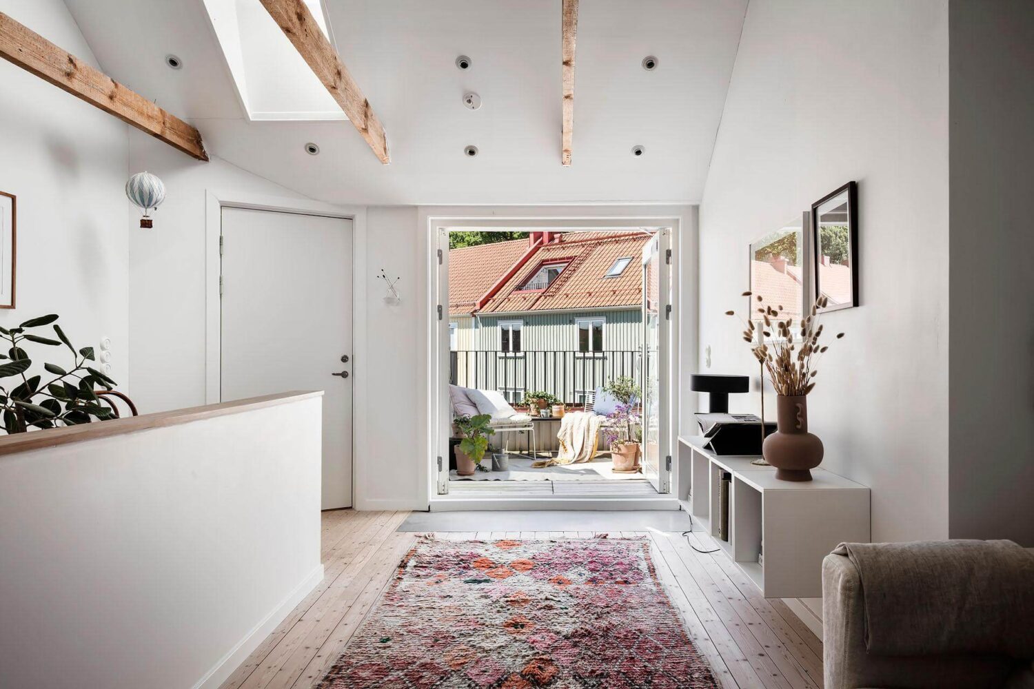 living-space-pink-rug-exposed-beams-roof-terrace-nordroom