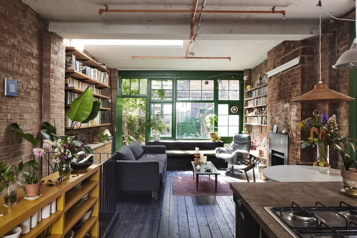 A Unique Home in a Former Furniture Workshop 1 open-plan-living-room-kitchen-black-wooden-floor-brick-walls-nordroom